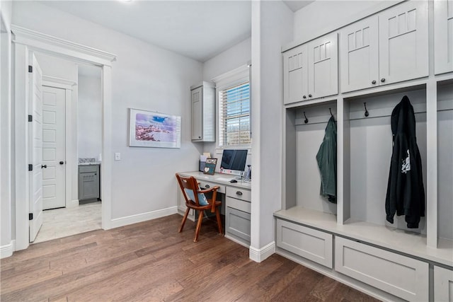 mudroom with wood finished floors and baseboards