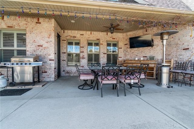 view of patio / terrace featuring outdoor dining area, a grill, and ceiling fan