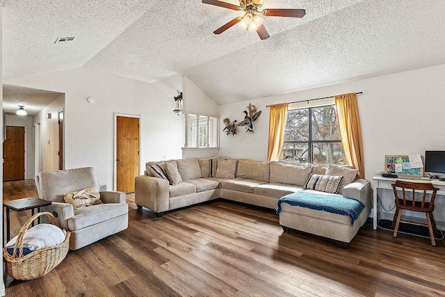 living room featuring visible vents, vaulted ceiling, wood finished floors, a textured ceiling, and a ceiling fan