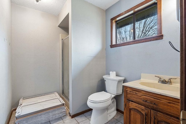 bathroom featuring vanity, a stall shower, a textured ceiling, tile patterned floors, and toilet