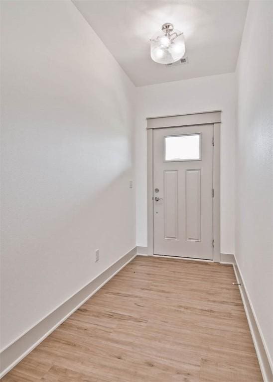 entrance foyer with visible vents, baseboards, and light wood-type flooring