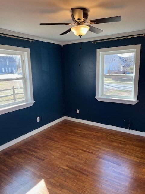 spare room with wood finished floors, baseboards, and ceiling fan