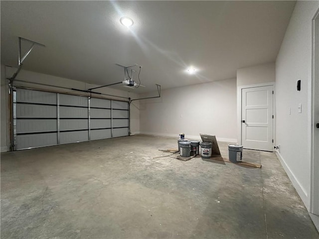 4412 W Bronco Dr, Fayetteville, AR 72704 - garage with a garage door opener and baseboards