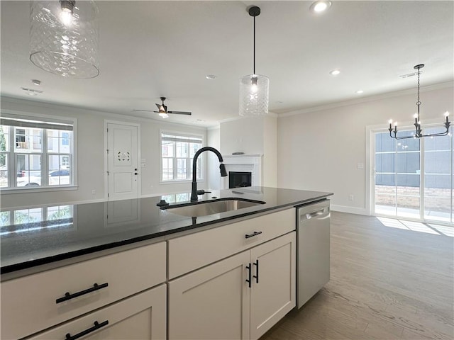 4412 W Bronco Dr, Fayetteville, AR 72704 - kitchen featuring dishwasher, a chandelier, a fireplace, crown molding, and white cabinets