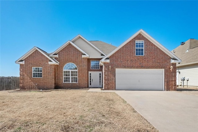 traditional-style house featuring brick siding, concrete driveway, a front lawn, and fence