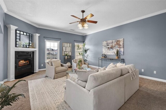 carpeted living area with a fireplace with flush hearth, baseboards, and ornamental molding