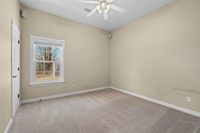 spare room with baseboards, visible vents, and carpet floors