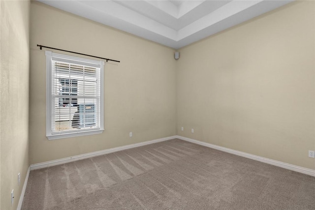 carpeted empty room featuring baseboards