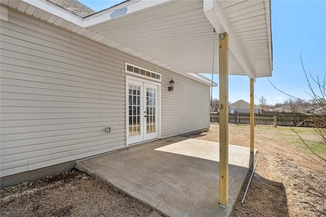 view of patio with french doors and fence