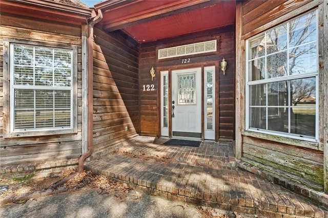 doorway to property featuring covered porch