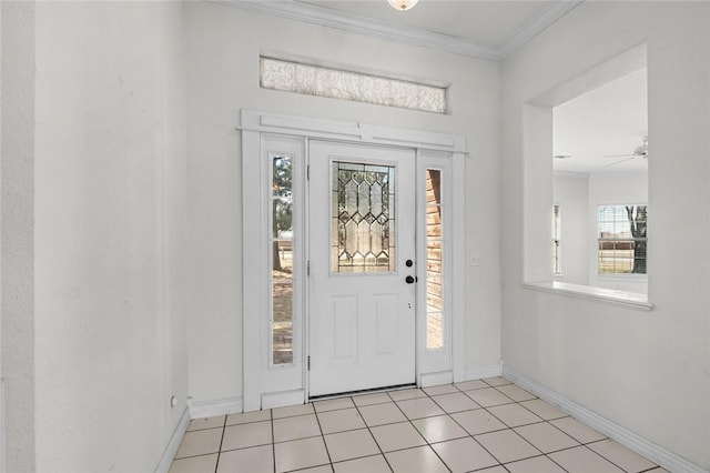 entryway with light tile patterned floors, baseboards, and ornamental molding