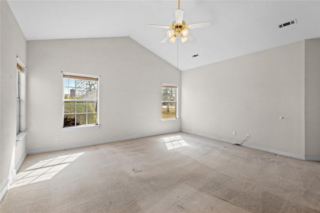 empty room with high vaulted ceiling, carpet flooring, visible vents, and ceiling fan