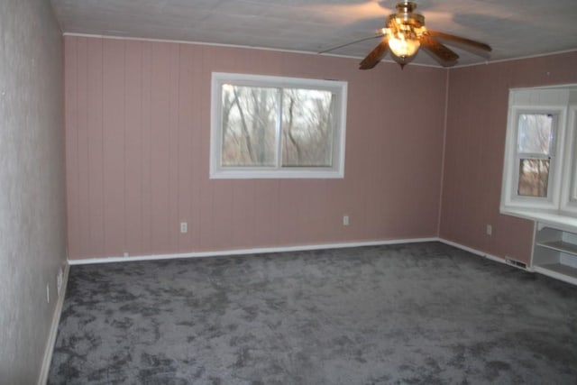 spare room with carpet flooring and a ceiling fan