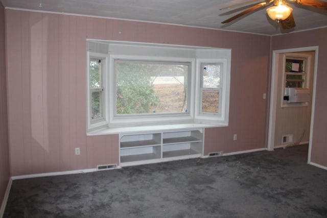 spare room featuring visible vents, a ceiling fan, and carpet floors