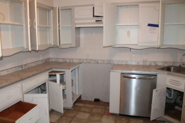 kitchen featuring backsplash, stainless steel dishwasher, white cabinets, and a sink