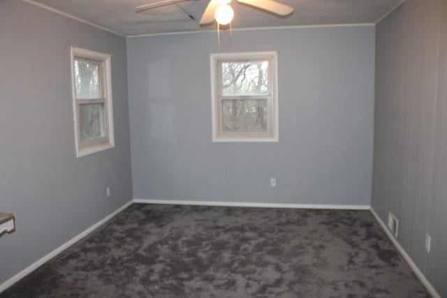 unfurnished room with carpet flooring, a ceiling fan, baseboards, and ornamental molding