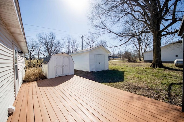 wooden deck with an outbuilding and a storage unit