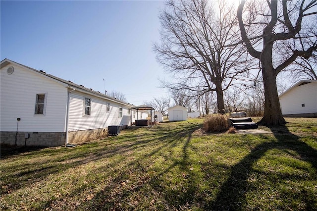 view of yard featuring an outbuilding, cooling unit, and a storage shed