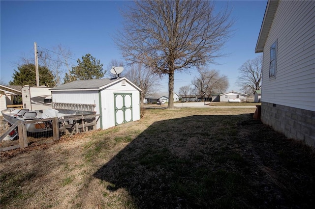 view of yard featuring an outbuilding and a shed