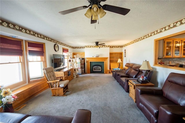 carpeted living area with a fireplace and a textured ceiling