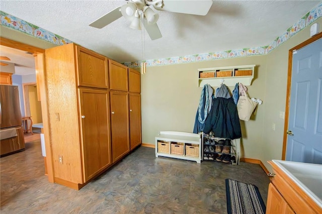 mudroom with a ceiling fan, baseboards, and a textured ceiling