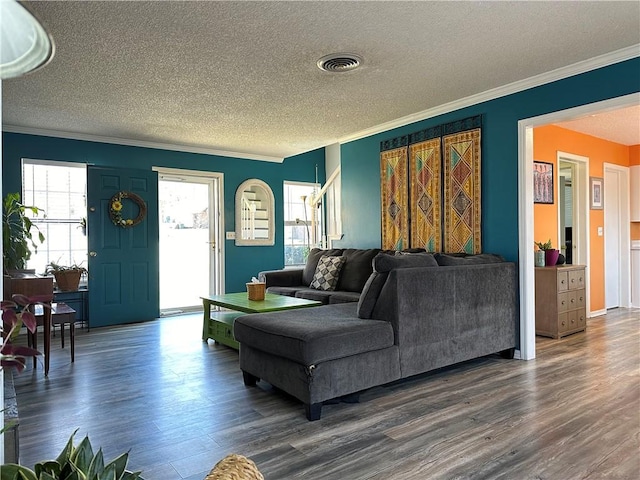 living room featuring plenty of natural light, dark wood-style floors, and visible vents