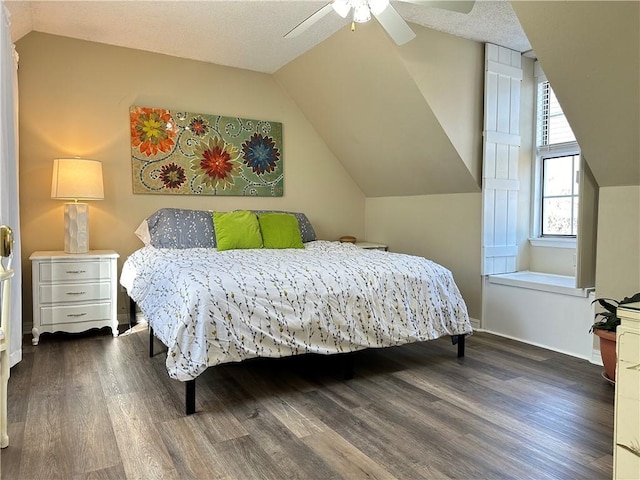 bedroom featuring dark wood-type flooring, ceiling fan, and vaulted ceiling