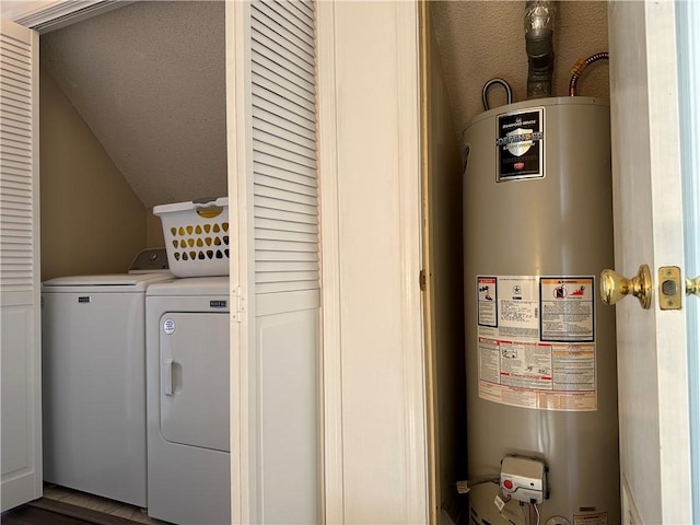 utility room with gas water heater and washing machine and dryer