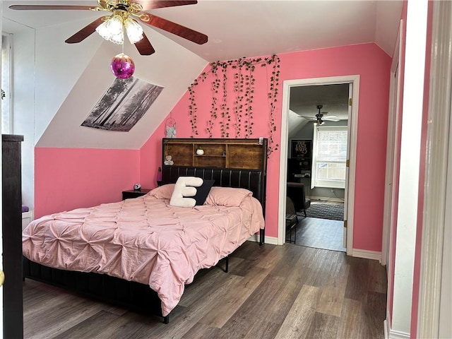 bedroom with lofted ceiling, wood finished floors, baseboards, and ceiling fan