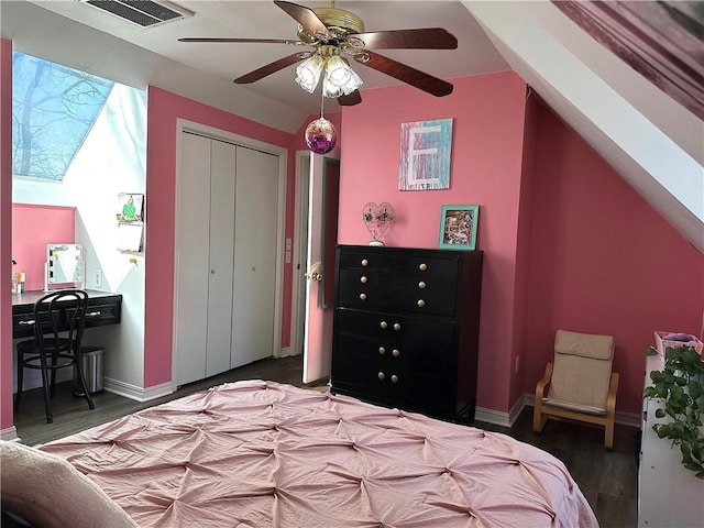 bedroom with a closet, visible vents, a ceiling fan, and wood finished floors