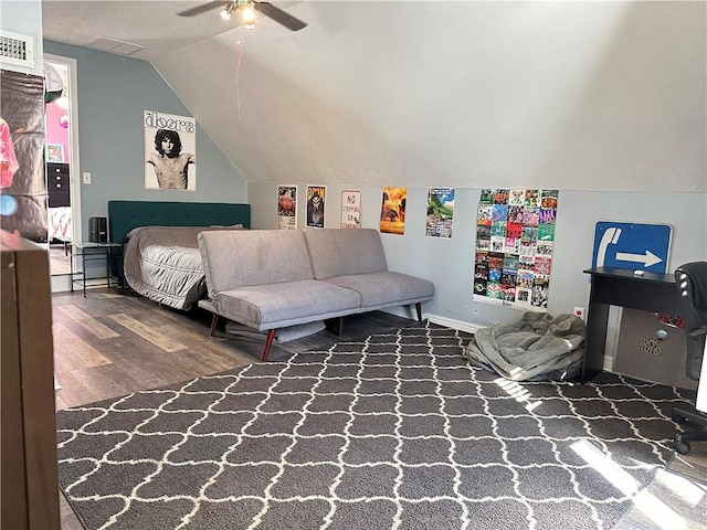 bedroom featuring visible vents, wood finished floors, baseboards, ceiling fan, and vaulted ceiling