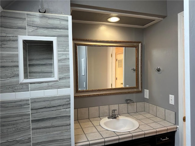 bathroom featuring ornamental molding and vanity