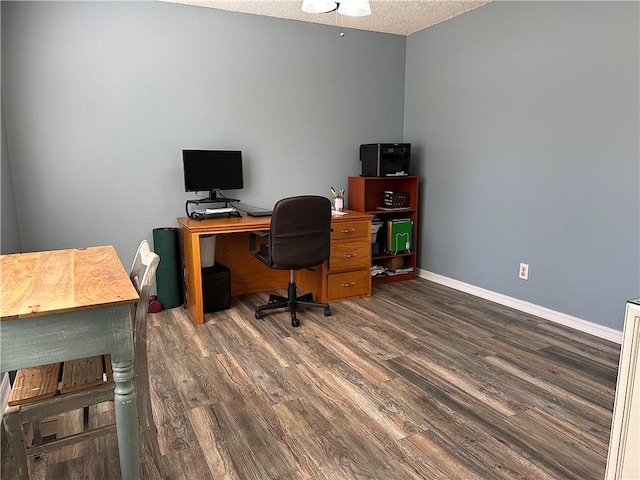 home office featuring baseboards, a textured ceiling, and wood finished floors