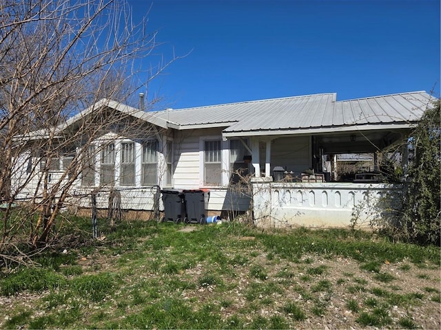 exterior space with covered porch and metal roof