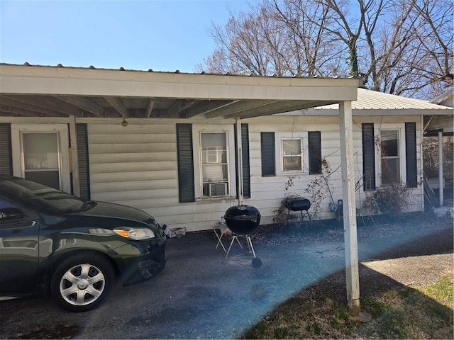 exterior space with a carport and metal roof