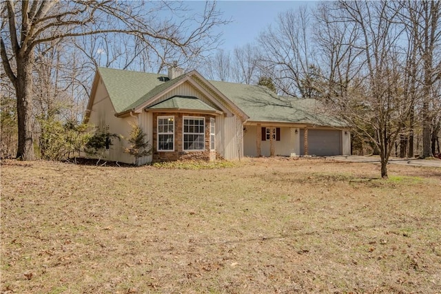 view of front of home with a chimney and a garage