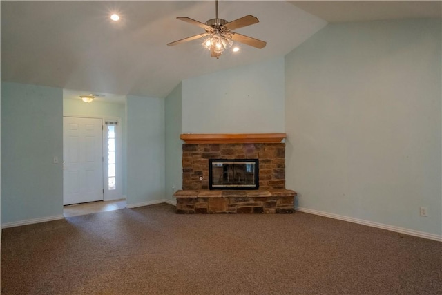 unfurnished living room with baseboards, a stone fireplace, carpet flooring, and vaulted ceiling