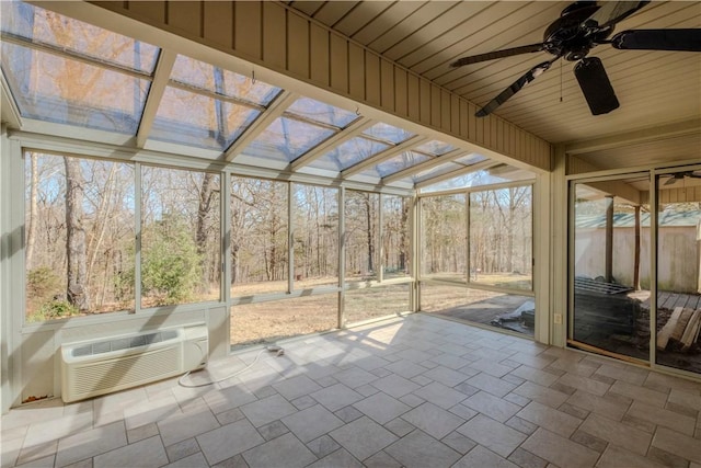 unfurnished sunroom featuring wood ceiling, an AC wall unit, and a ceiling fan