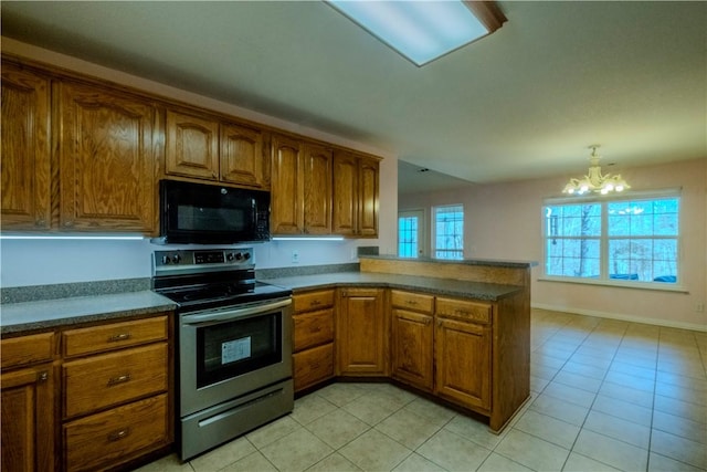 kitchen with black microwave, brown cabinets, stainless steel range with electric stovetop, a peninsula, and a notable chandelier