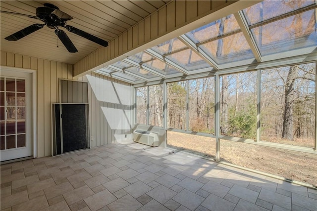 unfurnished sunroom featuring ceiling fan