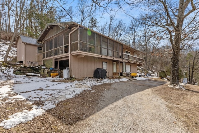 exterior space with driveway and a sunroom