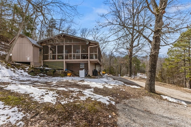 view of front of house with driveway and a sunroom