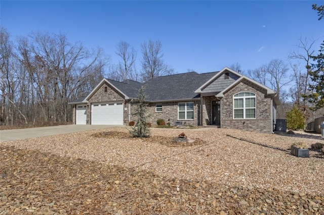 view of front of home featuring a garage, brick siding, and driveway