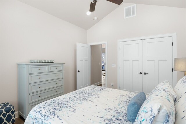 bedroom with visible vents, ceiling fan, baseboards, lofted ceiling, and a closet