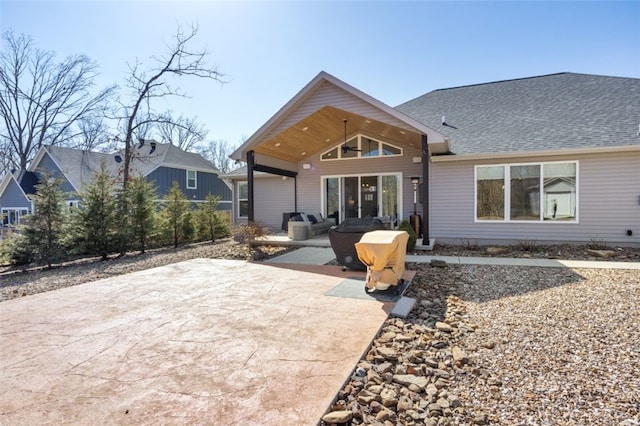 rear view of house with a patio, ceiling fan, and roof with shingles