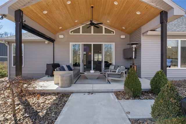 rear view of house with a shingled roof, ceiling fan, outdoor lounge area, and a patio area