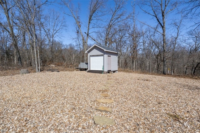 view of yard featuring a storage shed and an outbuilding