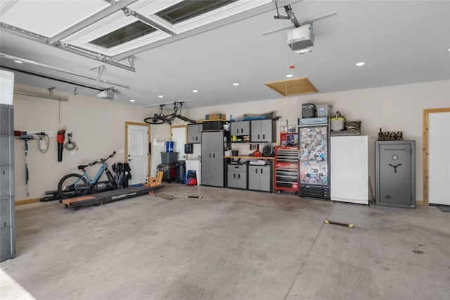 garage with recessed lighting, refrigerator, and a garage door opener