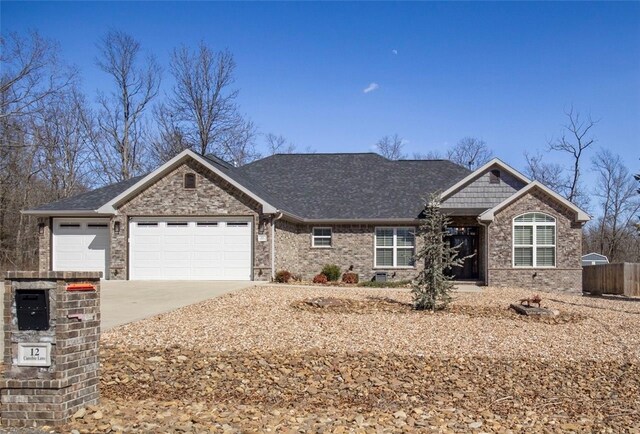 single story home featuring brick siding, an attached garage, concrete driveway, and fence