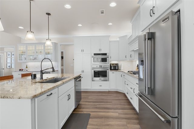 kitchen featuring white cabinetry, tasteful backsplash, appliances with stainless steel finishes, and a sink